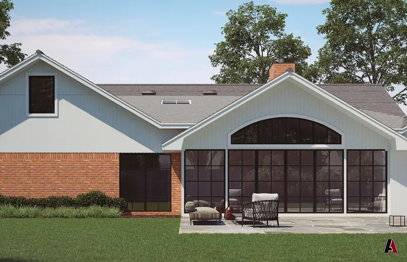 Rear addition with steel-frame windows and stone patio, designed by A1 Design and Construction